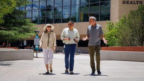 Kiran Bhaskar, PhD, center, and Bryce Chackerian, PhD, right, walking on UNM North Campus with Janice Knoefel, MD, a UNM neurologist and geriatrician who was instrumental in recruiting patients for the study. Photo Credit: Allan Stone TAU walking on north campus